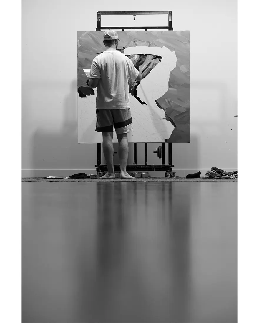 The artist painting a large canvas